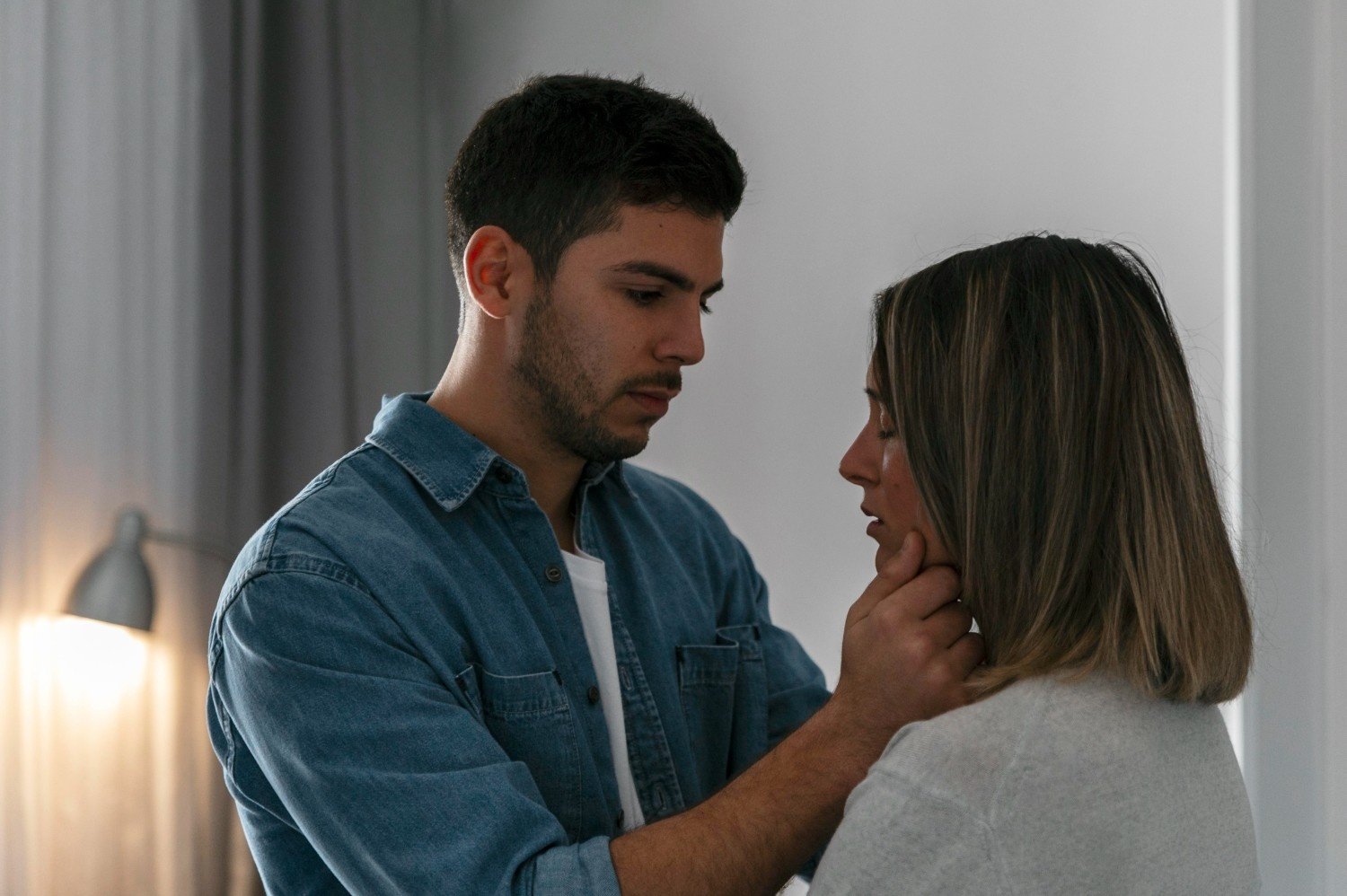 A man calmly comforting a woman during an emotional moment, reflecting emotional control and compassion in a healthy relationship boundary.
