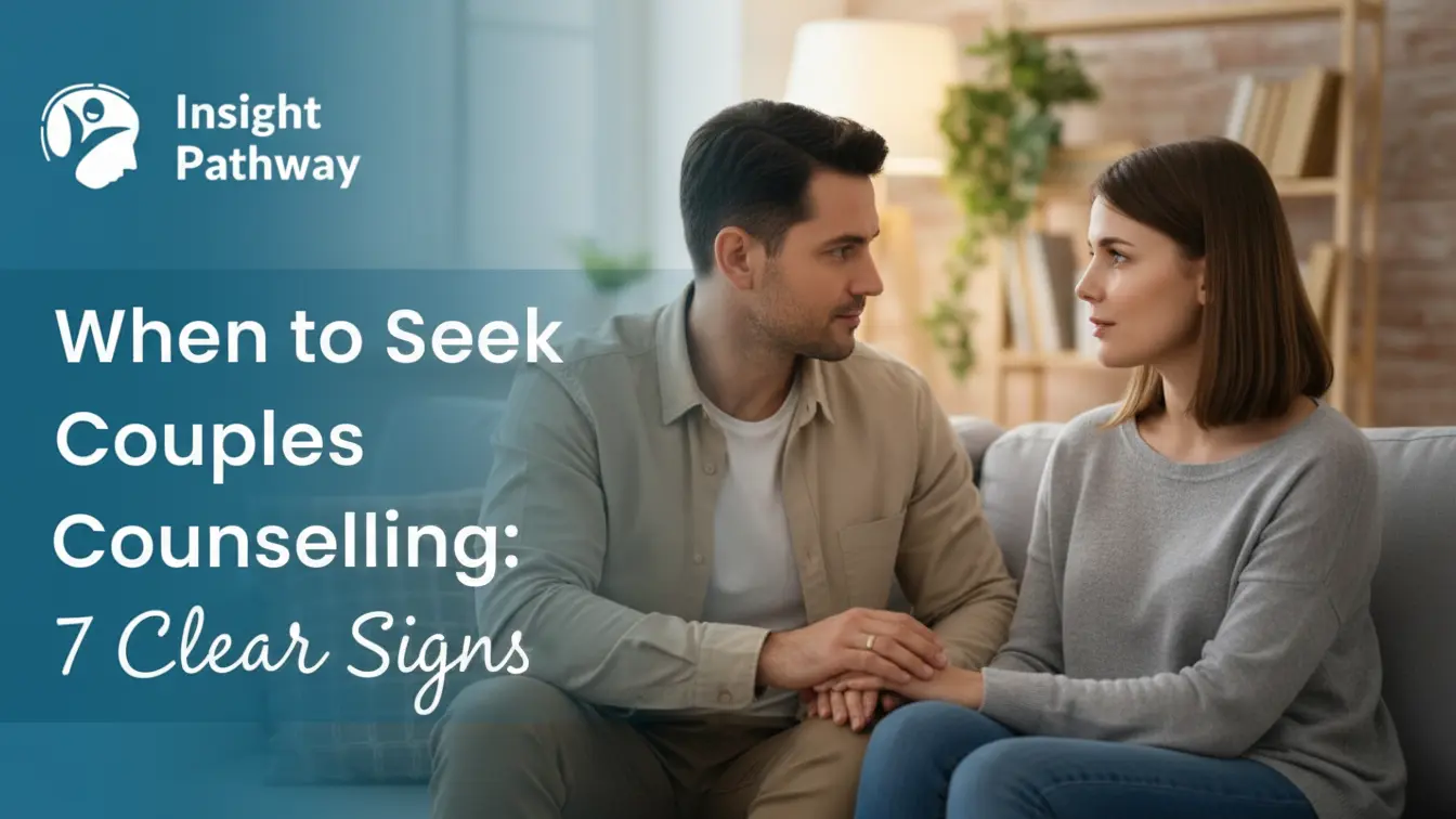 A couple sitting together on a sofa and talking seriously in a calm home setting, illustrating When to Seek Couples Counselling for improving understanding and emotional connection, with Insight Pathway branding visible.